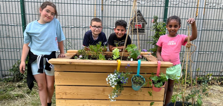 Children planting plants in the school garden.